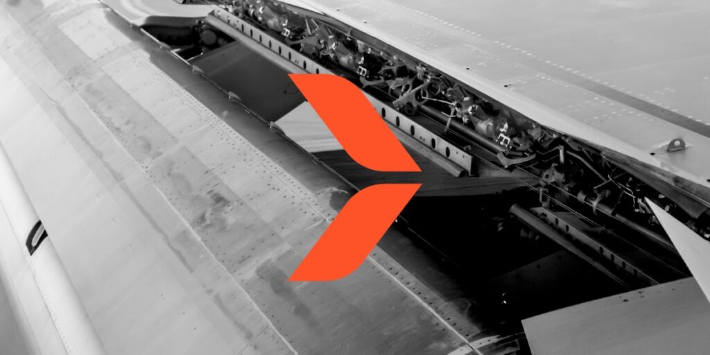 Un Airfoil naranja, símbolo del equipo de Carga Crítica de xpd global, está sobre la foto de un flap de avión. Lee este studio de caso para conocer los detalles del transporte de un flap de la Argentina a China utilizando nuestro skybridge por EUA.